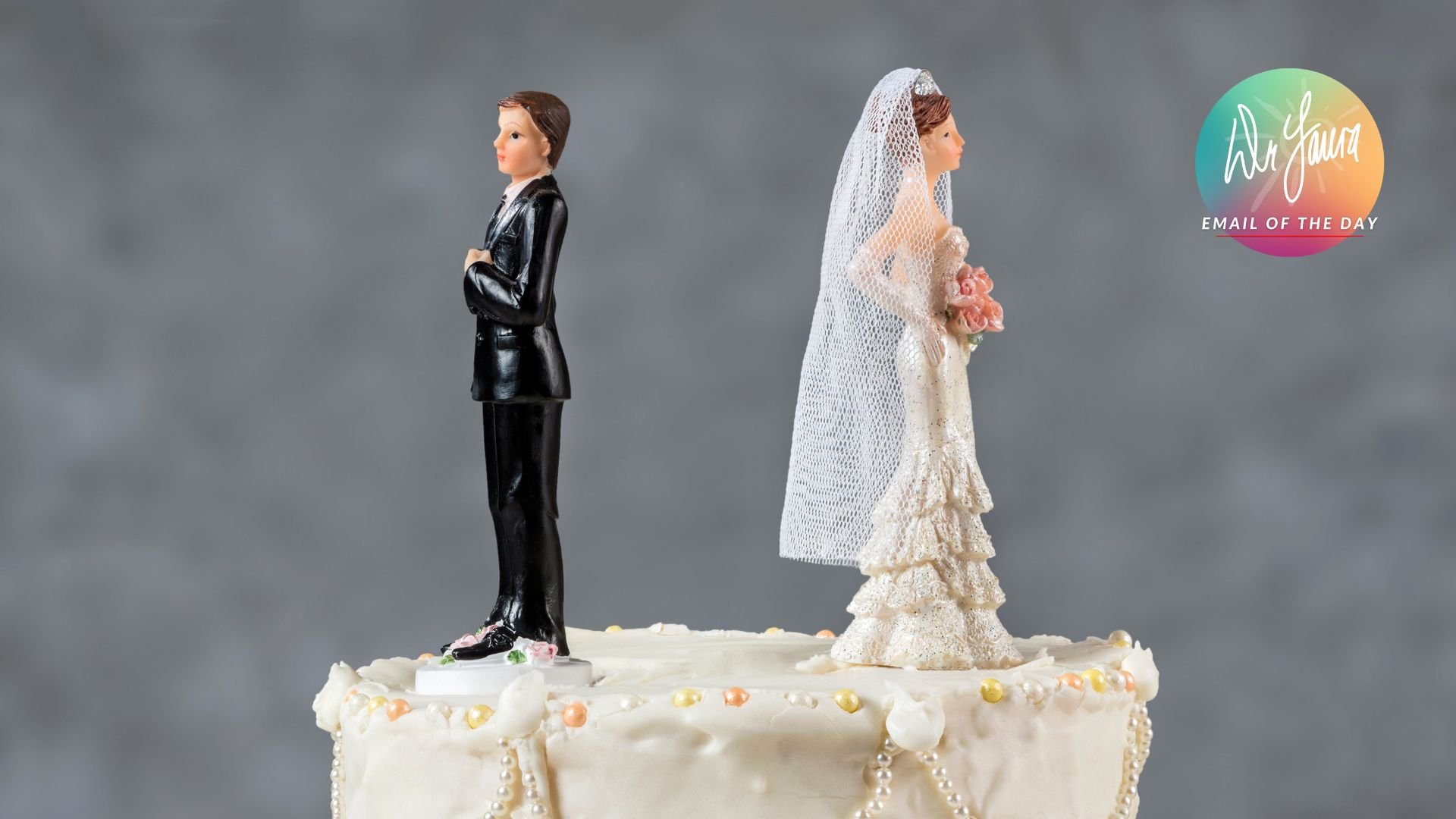 Bride and groom cake toppers face away from each other