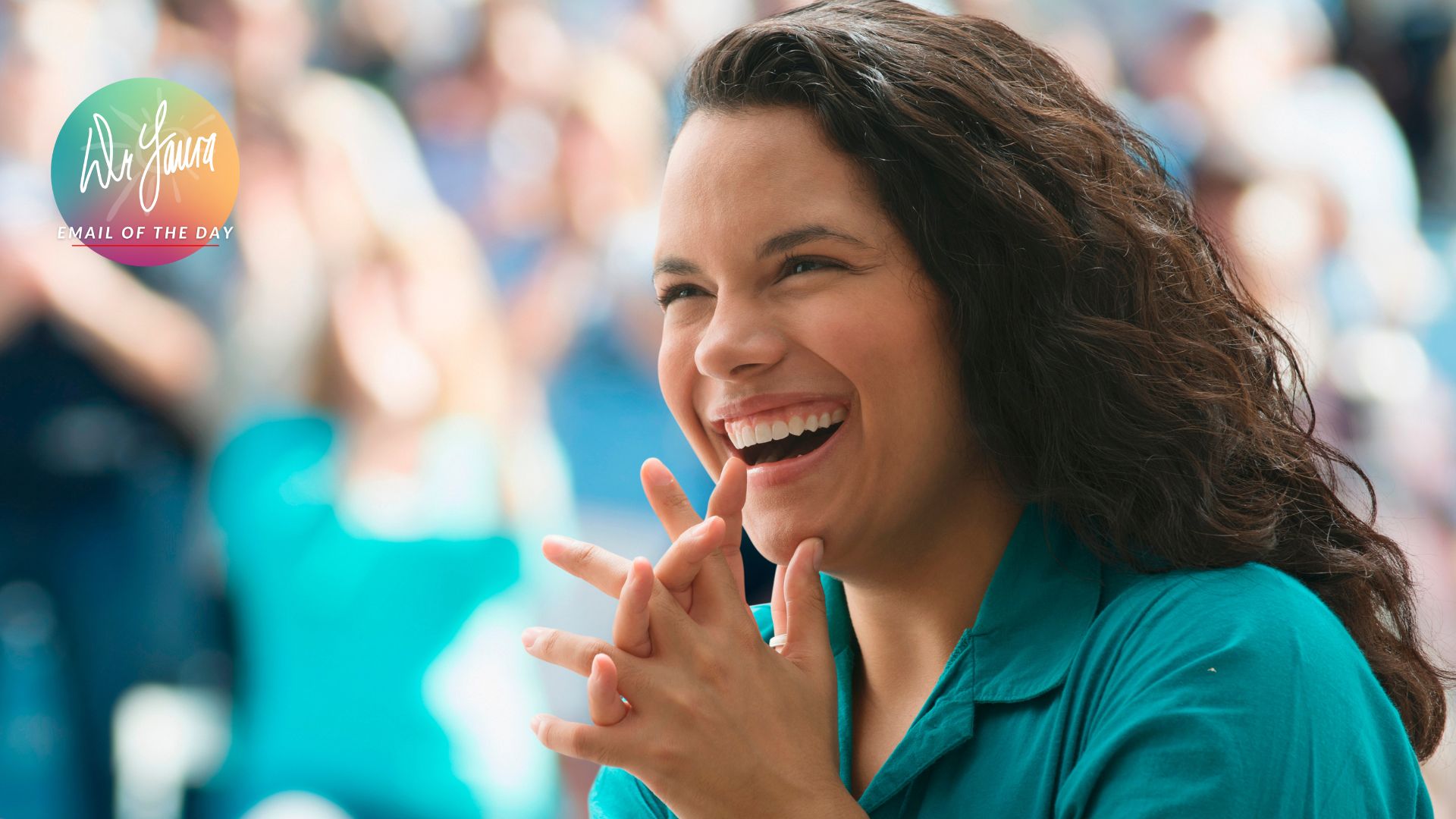 Woman in green-collared shirt smiles while clasping her hands