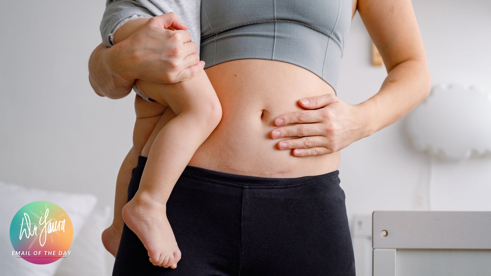Woman's torso is displayed while one hand is placed on her belly and the other holds a toddler on her hip