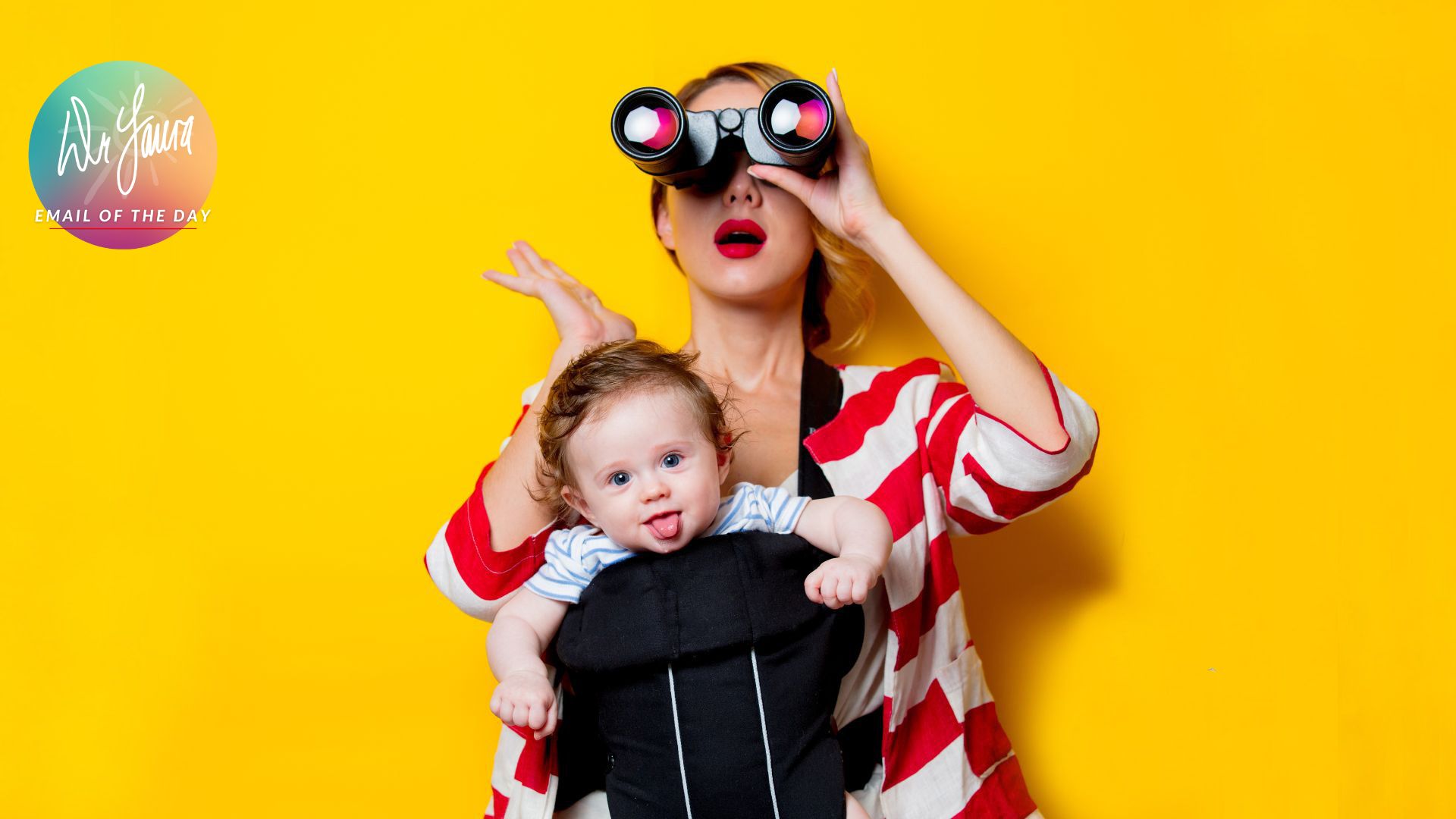 Woman in striped white-and-red shirt wears baby in baby carrier and holds binoculars up to her eyes