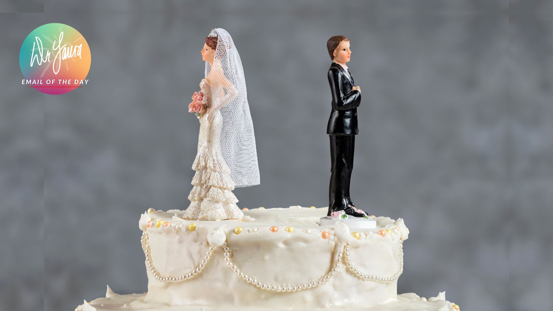Wedding cake topper with bride and groom figures facing away from each other