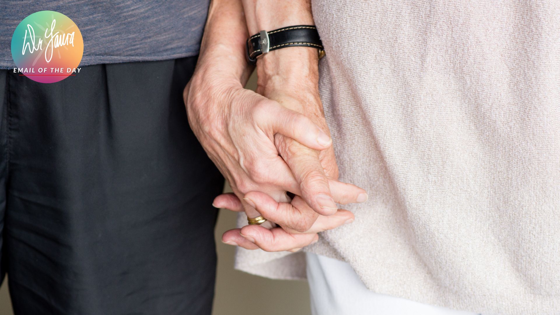 Elderly male and female hands intertwine