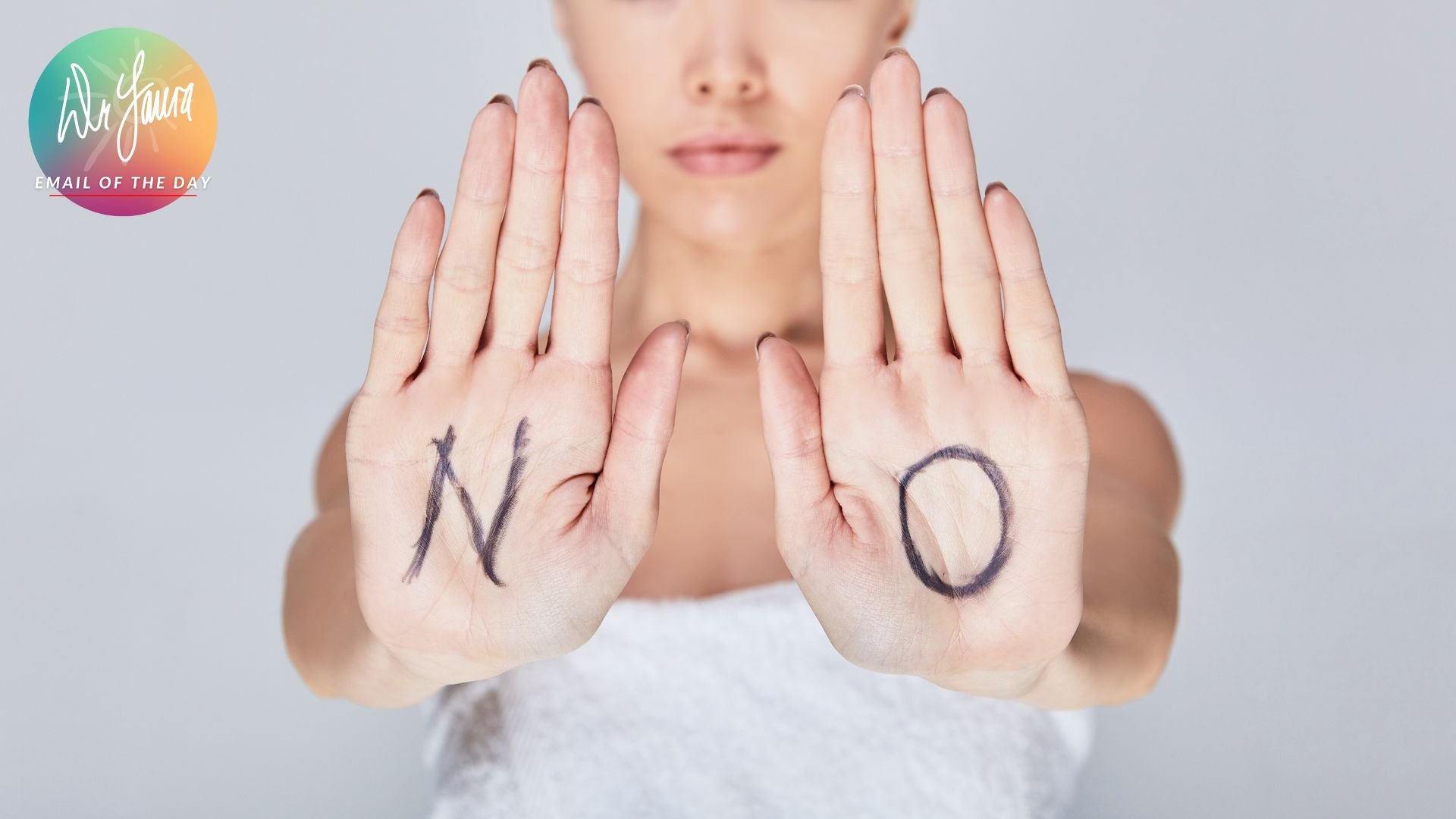 Woman holds up the palms of her hands that have the letters "N" and "O"