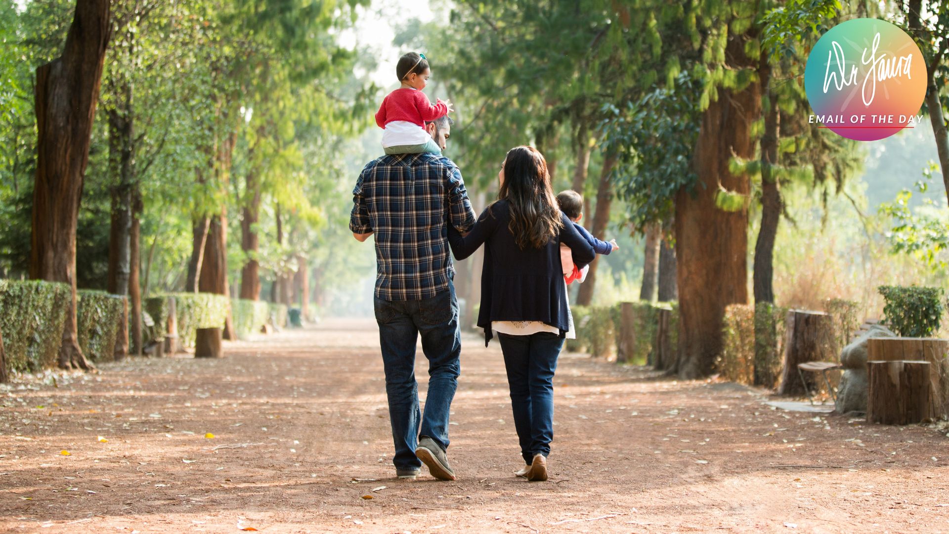 Man and woman walk next to each other while both hold a baby in their arms