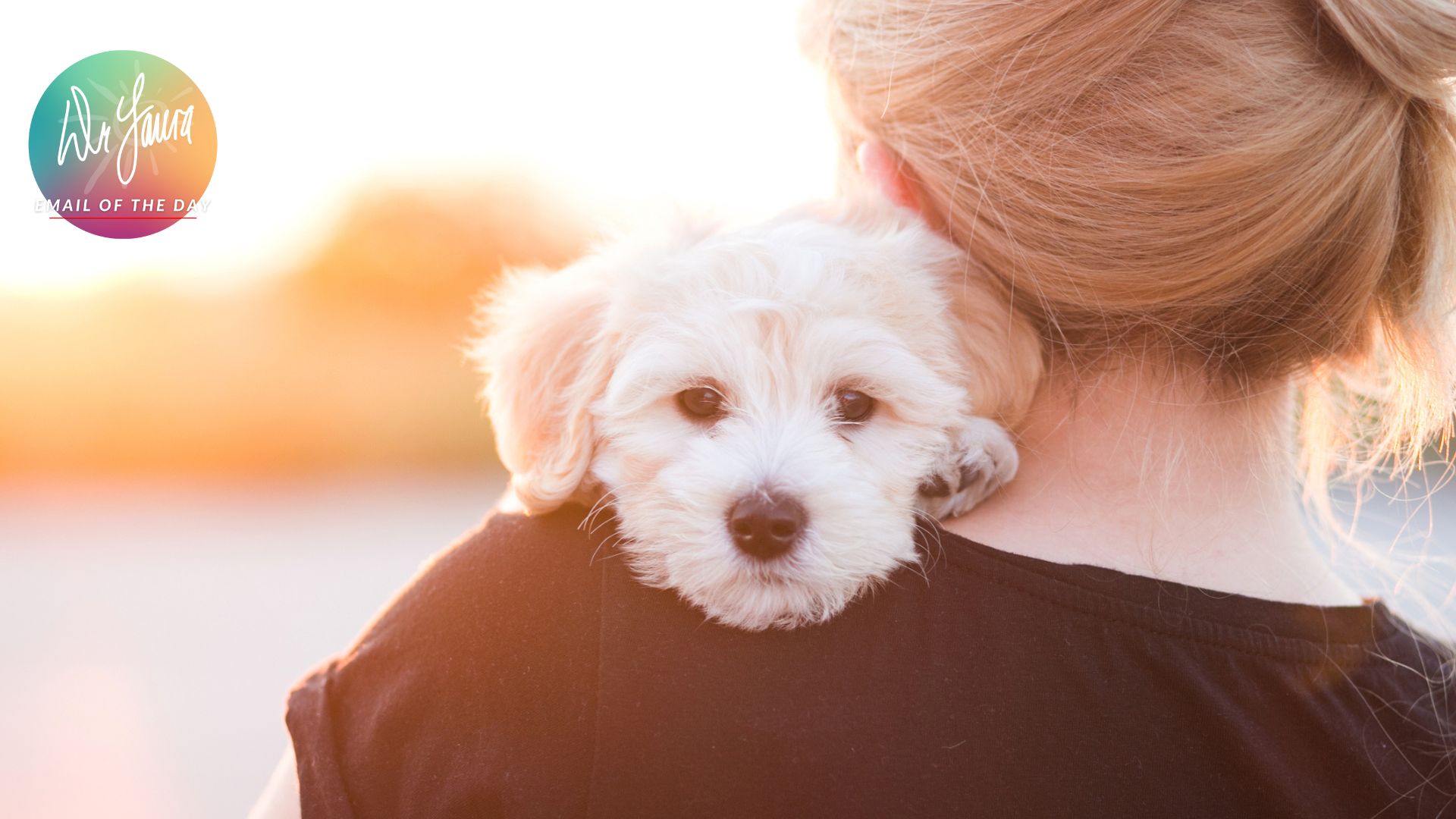 Woman holds white dog on her chest while dog's face rest on her shoulder